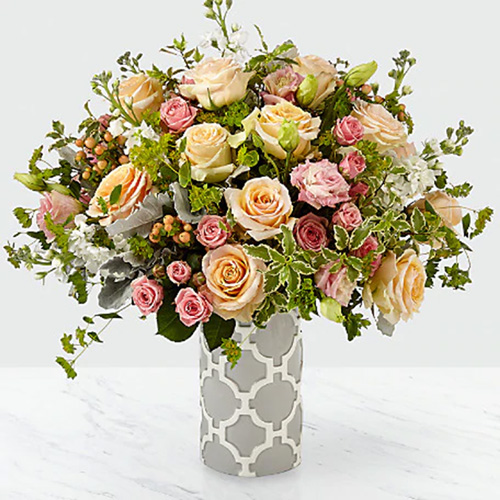 Assorted Pink and Peach Roses in a Vase with Greens